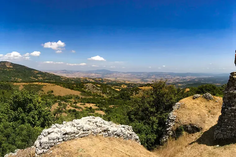 A wide valley seen from a limestone outcrop