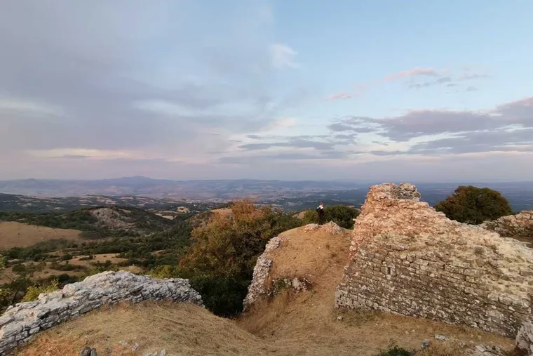 The ruined rock of Montevitozzo standing on its ridge above the valley